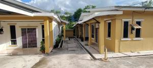 a row of yellow houses in a street at Ayem Resort Langkawi in Air Hangat