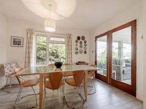 a dining room with a table and chairs at Five Bays View in Aberporth +23 photos