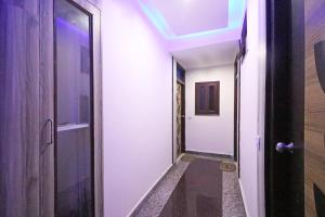 a hallway with a door and a blue ceiling at Super Hotel O Sweet Palace in New Delhi
