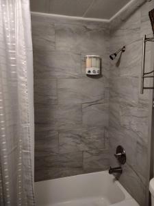 a bathroom with a white bath tub and a sink at Sunsets and City Lights 3BD 2Bath in Miramonte +38 photos