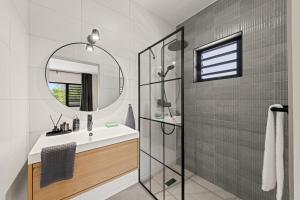 a bathroom with a sink and a mirror at Villa Anosia Laman i Tera in Westpunt +20 photos