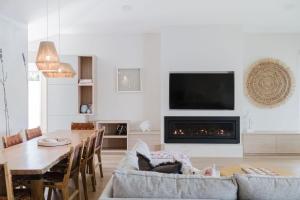 a living room with a table and a fireplace at Lakeside House - Waterfront, Spacious, Pool Table in Yatte Yattah