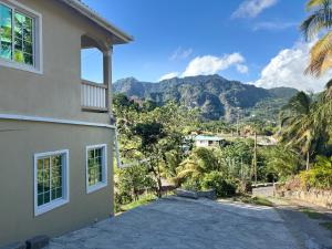 a house with a view of a mountain at Green Valley Luxe Apartments in Kingstown