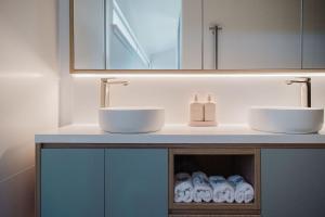 a bathroom with two sinks on a counter with towels at Lakeside House - Waterfront, Spacious, Pool Table in Yatte Yattah +26 photos