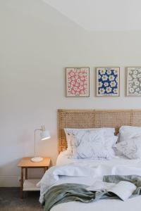 a bedroom with a bed and a table and pictures on the wall at Lakeside House - Waterfront, Spacious, Pool Table in Yatte Yattah