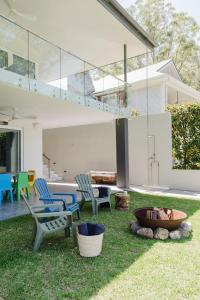 a backyard with chairs and a table and a fire pit at Lakeside House - Waterfront, Spacious, Pool Table in Yatte Yattah