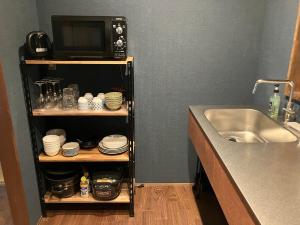 a kitchen with a sink and a microwave at goemon-inn in Akita +41 photos