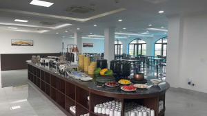 a restaurant with a buffet of food on a table at Army Hotel in Yen +12 photos