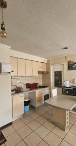 a kitchen with white cabinets and a table in it at Algarrobo, Pinares de Canelillo in Algarrobo