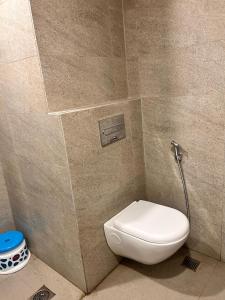 a bathroom with a toilet and a shower at D Haven Stays in Greater Noida