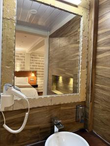a bathroom with a sink and a mirror at Hotel de Sal Atipax in Uyuni +57 photos