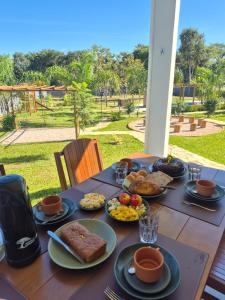 a table with plates of food on top of it at Chácara Reserva do Cerrado in Cavalcante