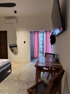 a bedroom with a table and a bed and a mirror at Departamento completo casarosa in Valladolid
