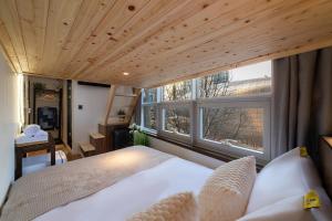 a bedroom with a bed and a large window at LAHA Boutique DDP Dongdaemun in Seoul +100 photos