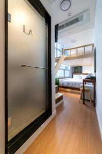a bedroom with a bunk bed and a sliding glass door at LAHA Boutique DDP Dongdaemun in Seoul