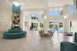 a lobby with blue couches and a table and chairs at Belle Maison Apartments - Official in Gold Coast
