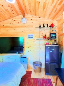 a bedroom with a bed and a clock on the wall at Foresta Karuizawa 6 "Glamping & Tent" for 8 people in Karuizawa