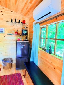a kitchen with a refrigerator and a window in a tiny house at Foresta Karuizawa 6 "Glamping & Tent" for 8 people in Karuizawa +16 photos