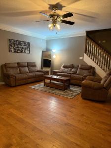 a living room with two couches and a table at Marion Getaway in Marion