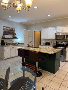 a large kitchen with white cabinets and a large island at Marion Getaway in Marion