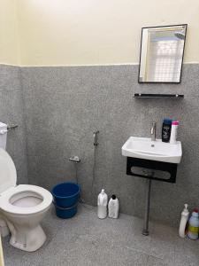 a bathroom with a toilet and a sink at Lanisa Staycation Mesra in Kampong Padang Bungor +21 photos