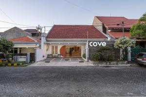 a house with a google sign on the front of it at Cove Amayana in Surabaya