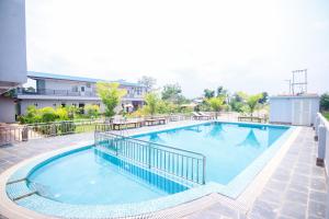 a large swimming pool on top of a building at Amazon Resort in Sauraha