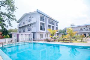 a building with a swimming pool in front of a building at Amazon Resort in Sauraha