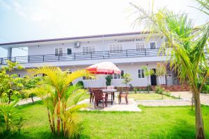 a patio with a table and chairs in front of a building at Amazon Resort in Sauraha +25 photos