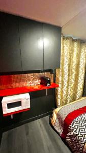 a bedroom with a microwave on a red shelf at Luxury KIA Room E in Richmond Hill +4 photos