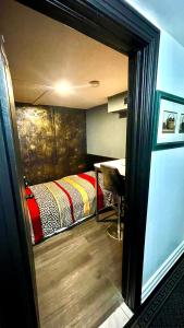 a small room with a bed and a table at Luxury KIA Room E in Richmond Hill