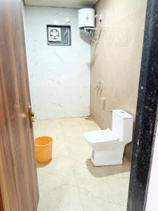 a bathroom with a toilet in a room at Mahendra place in Khātu