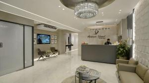 a lobby with a reception desk and a man in the background at Platinum Grand in Dhaka