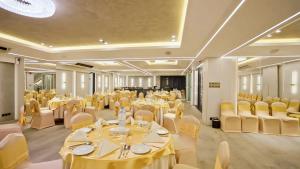 a banquet hall with white tables and yellow chairs at Platinum Grand in Dhaka +54 photos