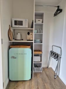 a small refrigerator in a kitchen with a microwave at Monarch Park Studio in Cambridge