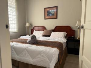 a bedroom with two beds and a picture on the wall at Lanisa Staycation Mesra in Kampong Padang Bungor