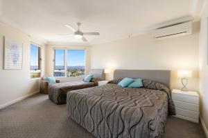 a bedroom with a bed and a couch at Belle Maison Apartments - Official in Gold Coast +117 photos