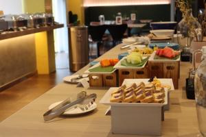 a long table with plates of food on it at The Brunei Hotel in Bandar Seri Begawan