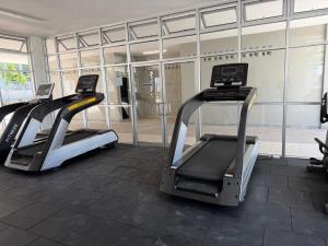 a gym with two treadmill machines in front of a building at Sufi Idaman Homestay for Islamic only in Nilai
