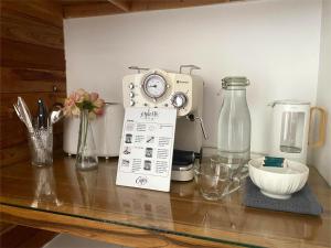 a kitchen counter with a mixer on a table at Nibbana Bungalows in Hinkong