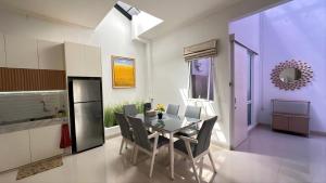 a kitchen and dining room with a table and chairs at Moses Home in Tjilandak +9 photos