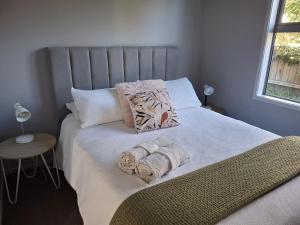 a bedroom with a bed with towels on it at The Coop in Kinloch