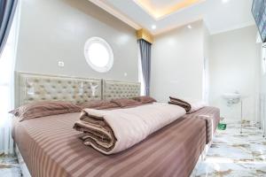 a bedroom with a large bed with brown pillows at M Villa in Jetis +43 photos