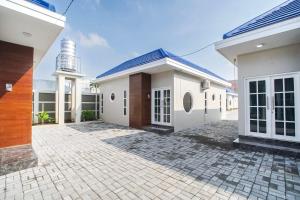 a white house with a brick driveway at M Villa in Jetis