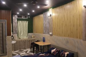 a room with a table and a table and chairs at Dipankar House in Tezpur