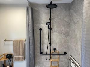 a shower in a bathroom with a black shower head at Go Glamping NZ Ltd in Alexandra