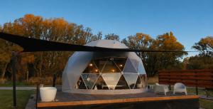 a tent with a table and chairs in a yard at Go Glamping NZ Ltd in Alexandra +16 photos