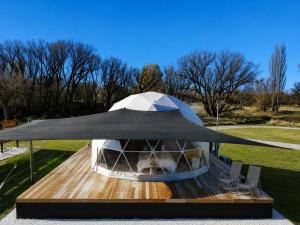 a gazebo with a tent on a wooden deck at Go Glamping NZ Ltd in Alexandra