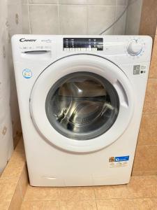 a white washing machine sitting in a room at Apartment Jorgo Kalithea in Kallithea Halkidikis +2 photos