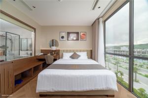 a bedroom with a bed and a large window at Solaya Hotel in Tài Xá +4 photos